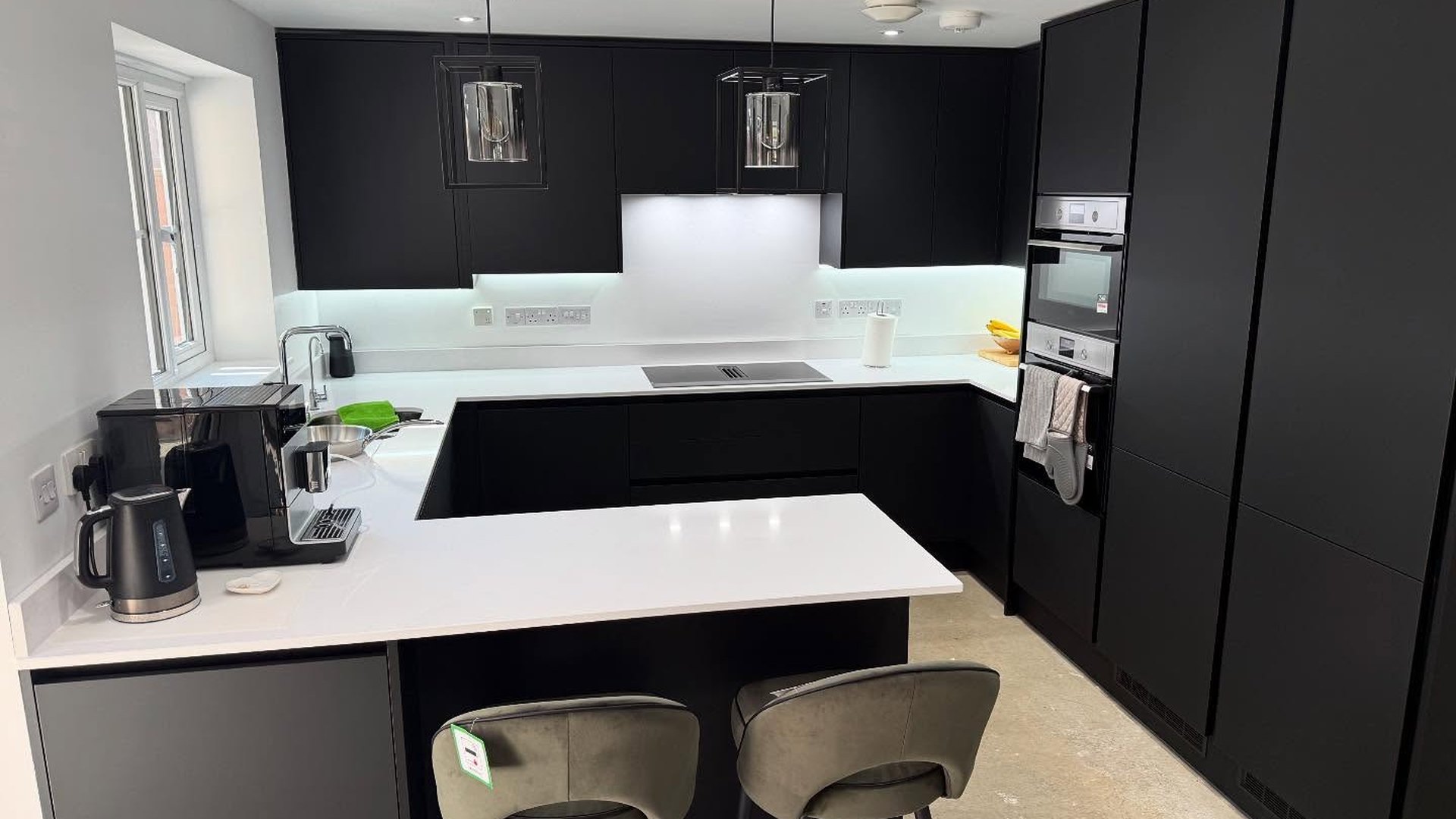 Matt black kitchen with white quartz worktops