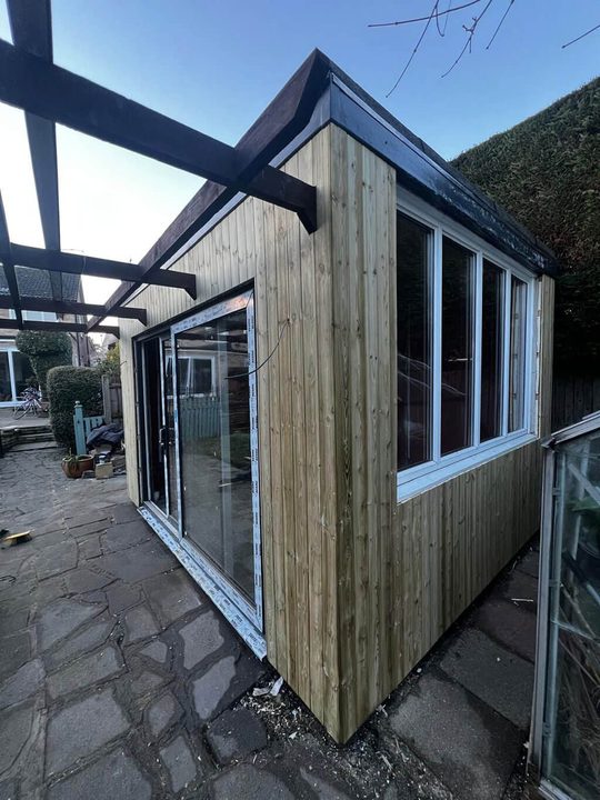 Insulated timber frame with the glazing fitted, ready for cladding