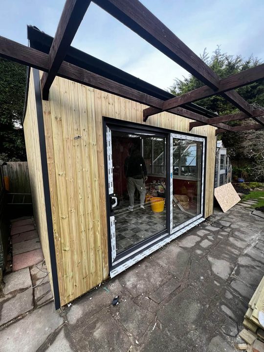 Timber frame with the glazing going in, the same stage every garden room goes through