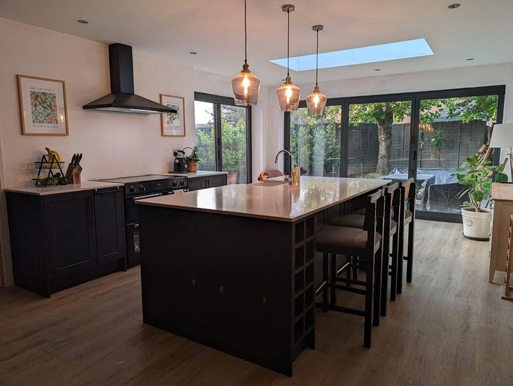 Kitchen island with copper pendants under a rooflight