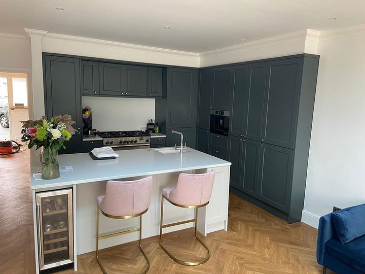 Renovated teal kitchen with brass handles