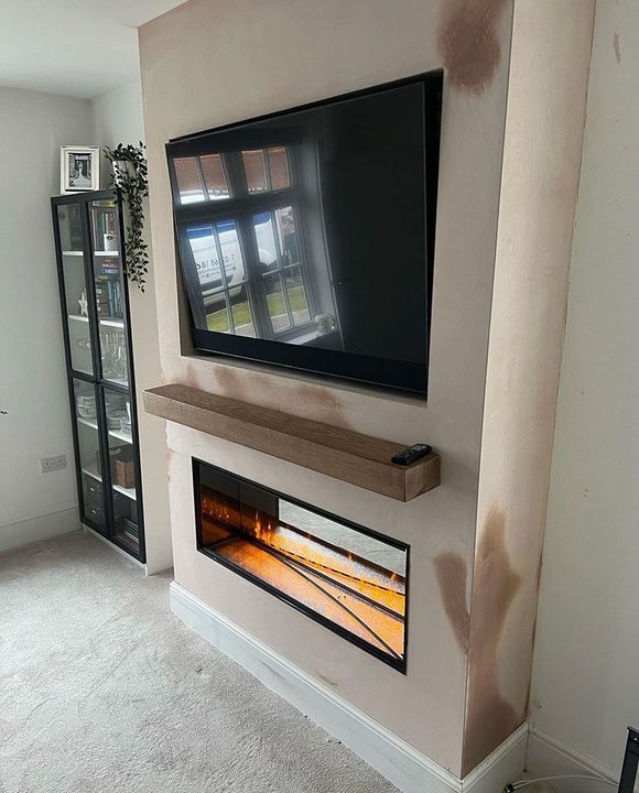 Media wall with a linear fire below a wall mounted screen